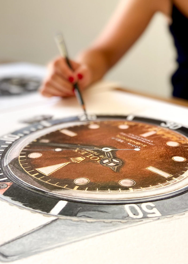Cecilia Mendoza drawing a Rolex Submariner Ref. 6538 in her studio in Italy with color pencils Caran d'Ache on Arches Paper