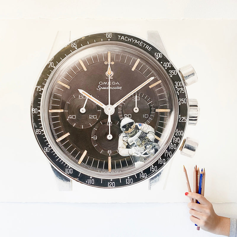 Close-up of a detailed watch face with a person holding pens in the background Cecilia Mendoza CM Visual Artist Ceciliaismyname Omega speedmaster Ed White moonwatch