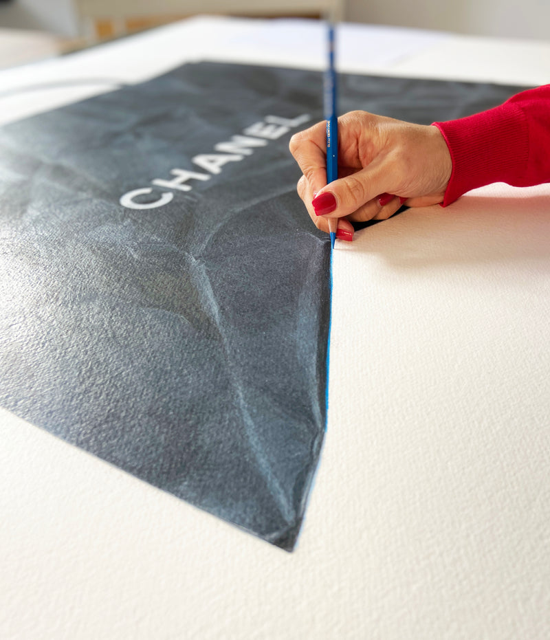 Cecilia Mendoza CM Visual Artist Drawing a Chanel paper bag with carat d'ache on Arches Paper